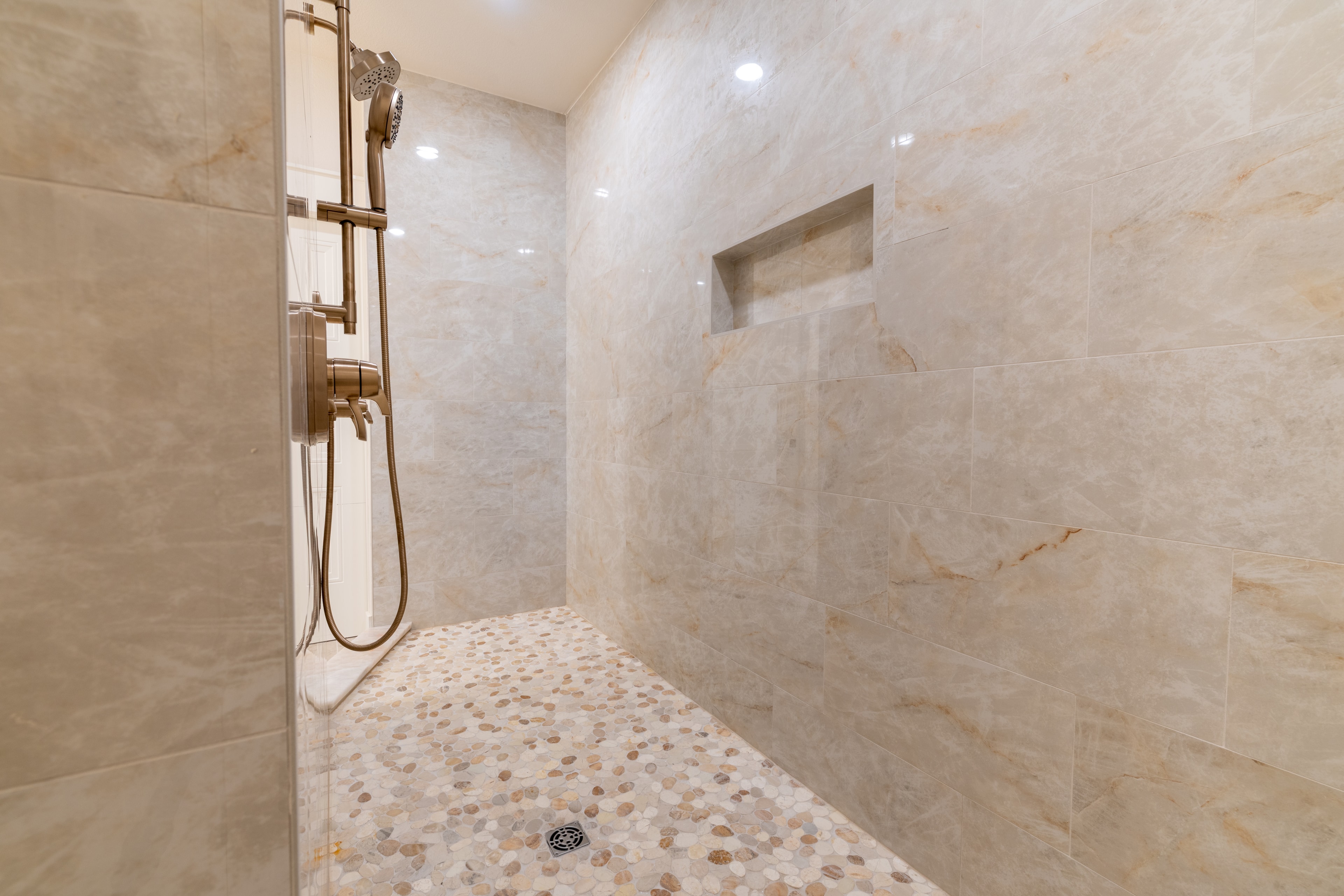 Luxury walk-in shower with marble tile
