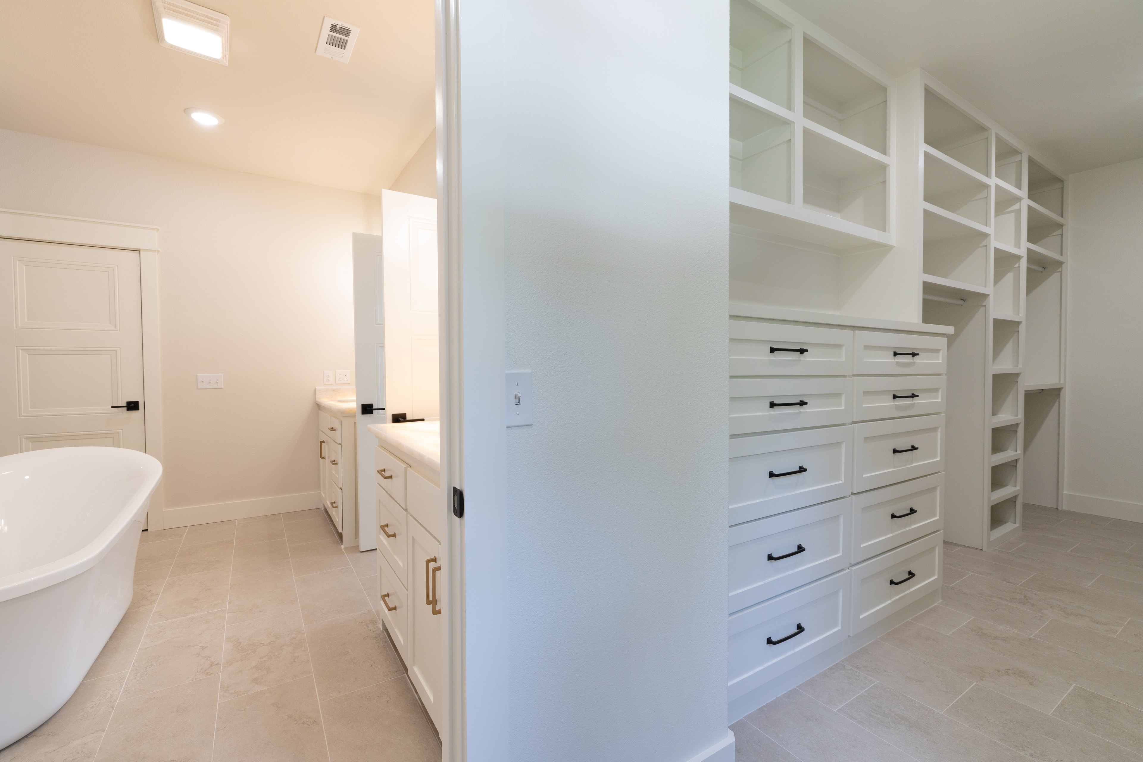 Master bathroom with freestanding tub and custom walk-in closet